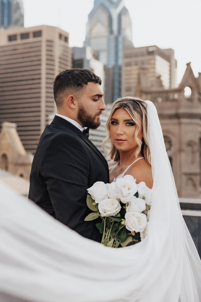 Philadelphia's skyline provides a romantic setting for Danielle and Dominic's rooftop engagement session, highlighting the city's charm and their love.