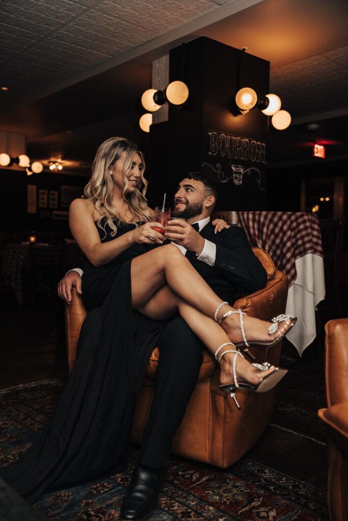 In the heart of Philadelphia, Danielle and Dominic's connection shines as they share a moment in the unique ambiance of PJ Clarkes for their engagement photos.