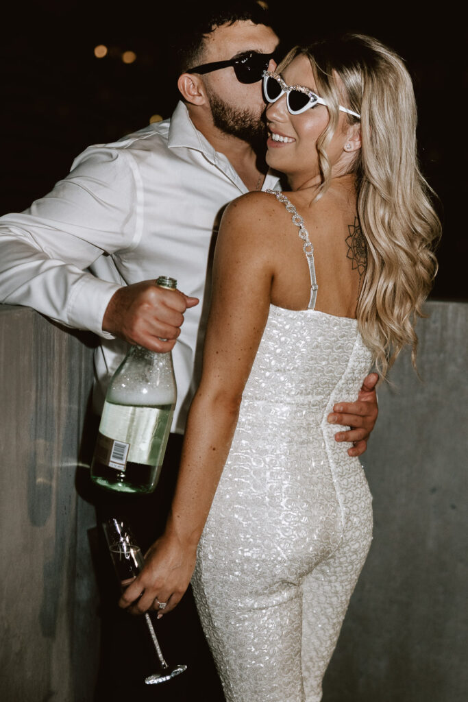 Philadelphia's skyline becomes the backdrop to a magical celebration as Danielle and Dominic pop champagne, bathed in the glow of flash photography.