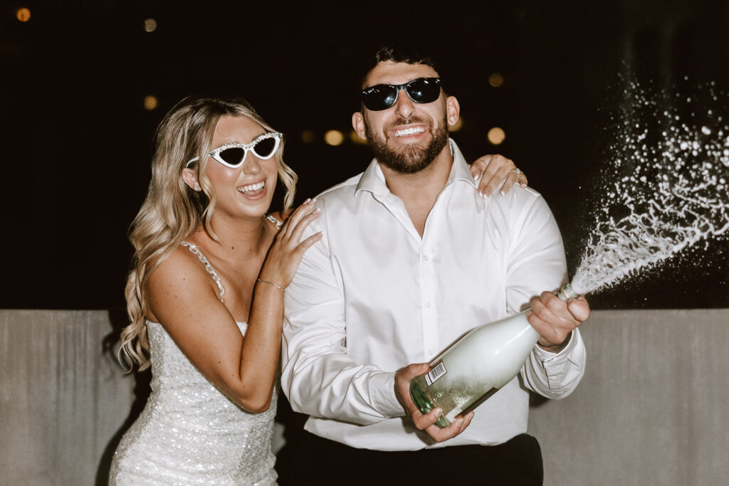 Flash photography enhances the glamour of Danielle and Dominic's rooftop toast, marking the grand finale to their dreamy Philadelphia engagement session.