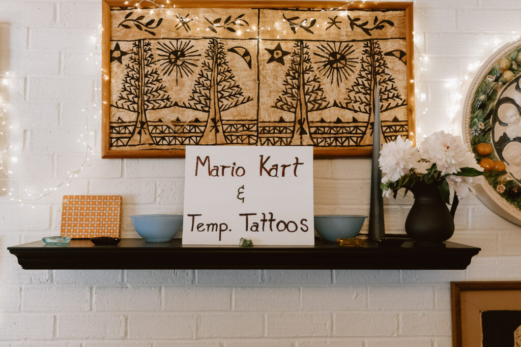 Fun and vibrant tattoo station at the wedding, featuring cat tattoos and astrology symbols, adding a whimsical and charming touch to the celebration.
