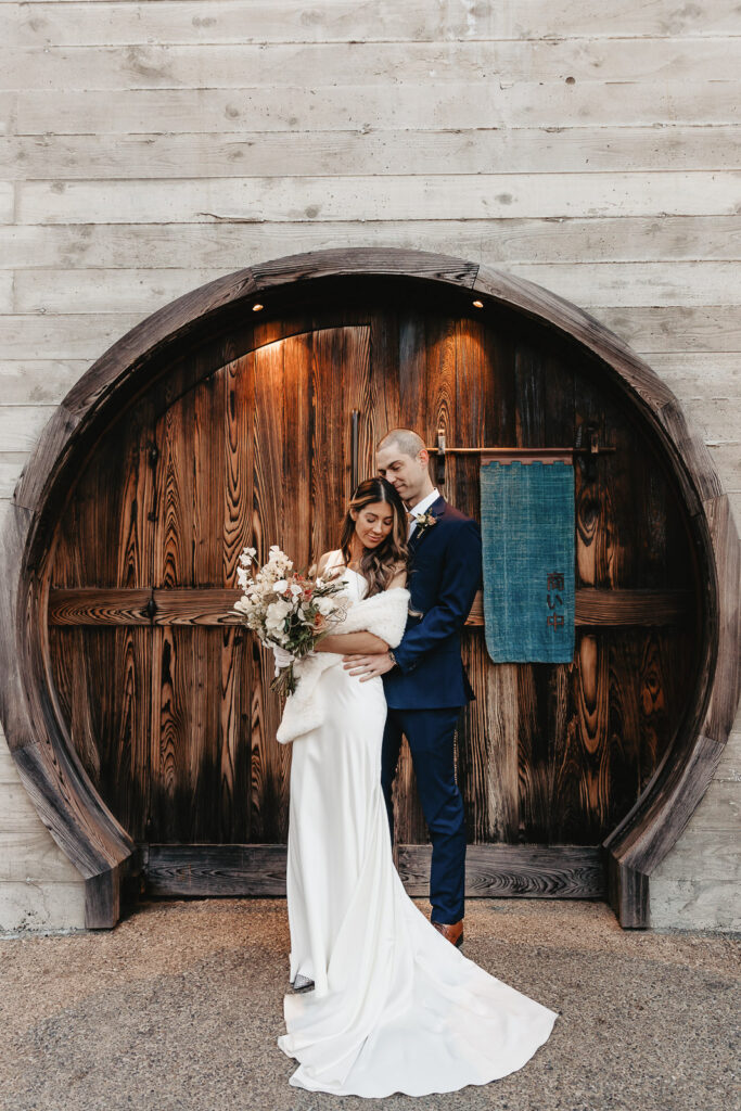 bride and groom embracing outside of la colombe coffee