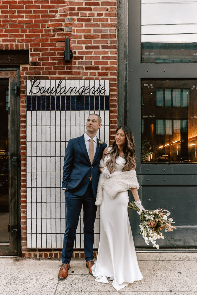 bride and groom locking arms outside of la colombe coffee