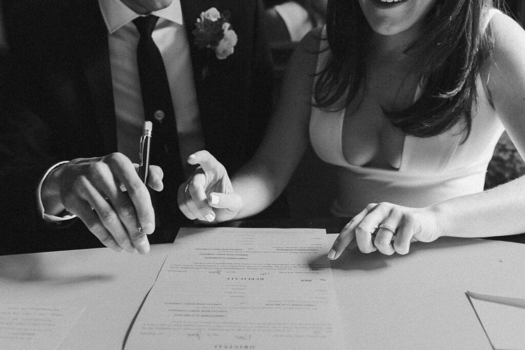 bride and groom signing their marriage license at the guild house hotel in philadelphia