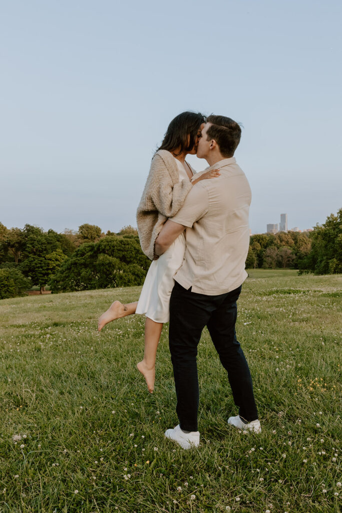 couple kissing at belmont plateau for their engagement photos in philadelphia