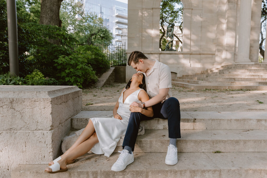 couple embracing on the steps at Rodin Museum for their engagement photos in Philly