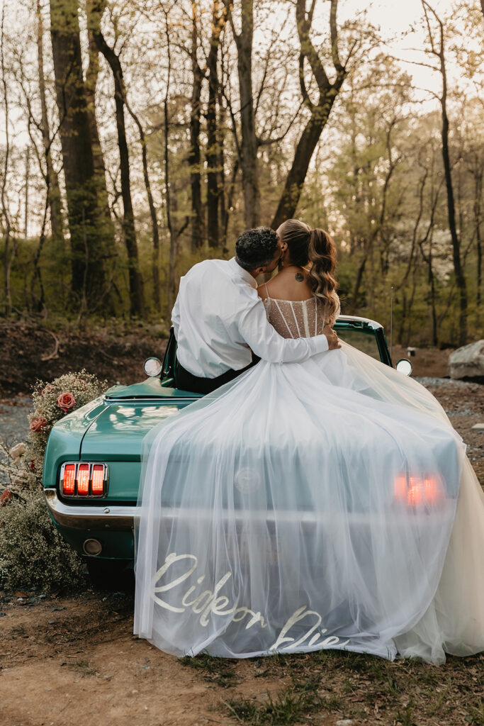bride and groom sitting on a vintage car for their pennsylvania elopement
