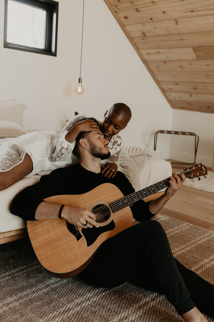 bride and groom embracing with guitar at texter mountain home for their pennsylvania elopement