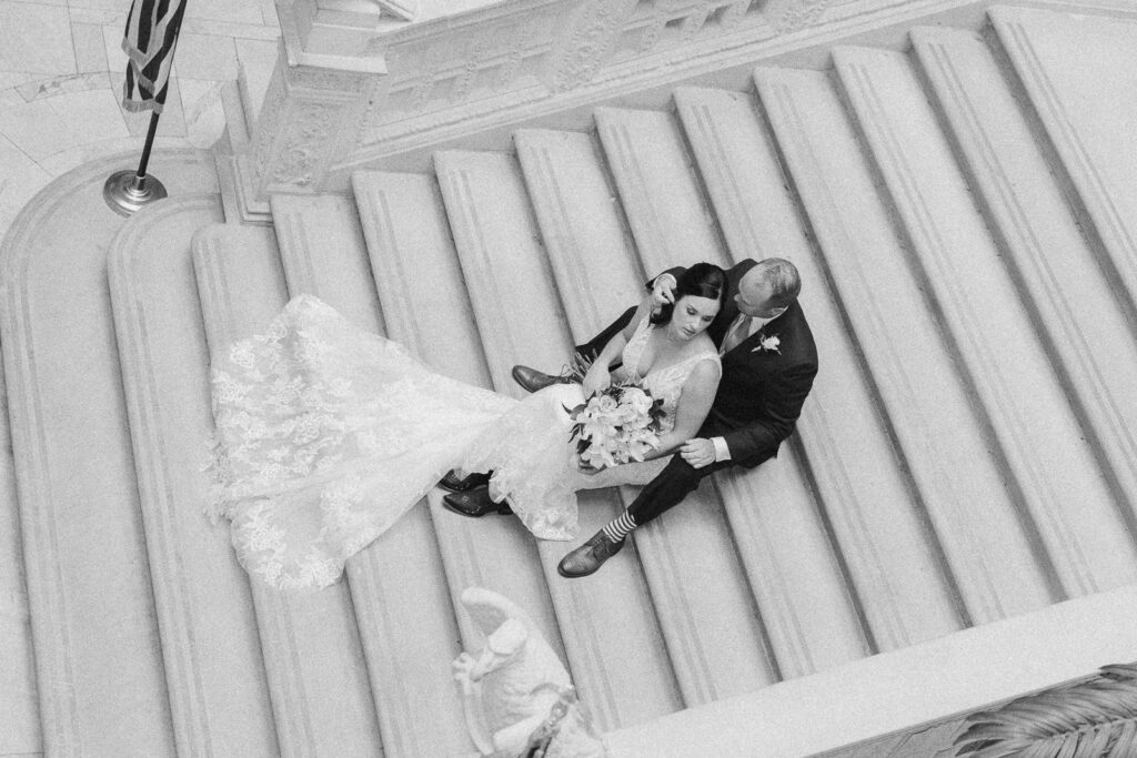 bride and groom on stairs at the Pennsylvania State Capitol for their Pennsylvania elopement