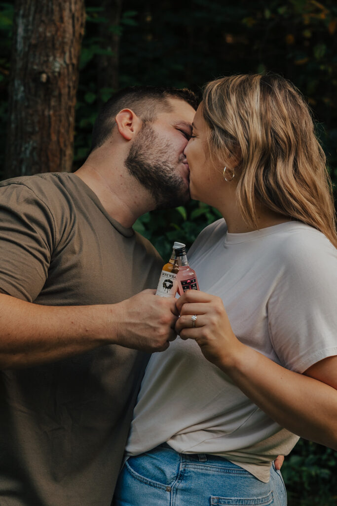 couple kissing at their outdoor engagement photos