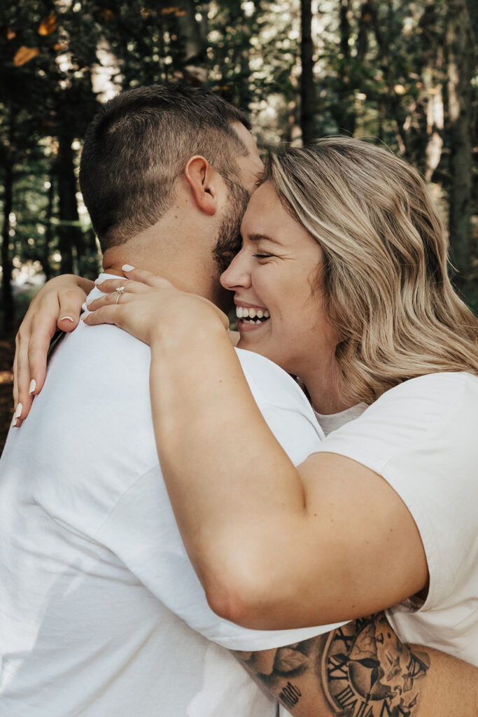 couple embracing at their outdoor engagement photos in pennsylvania