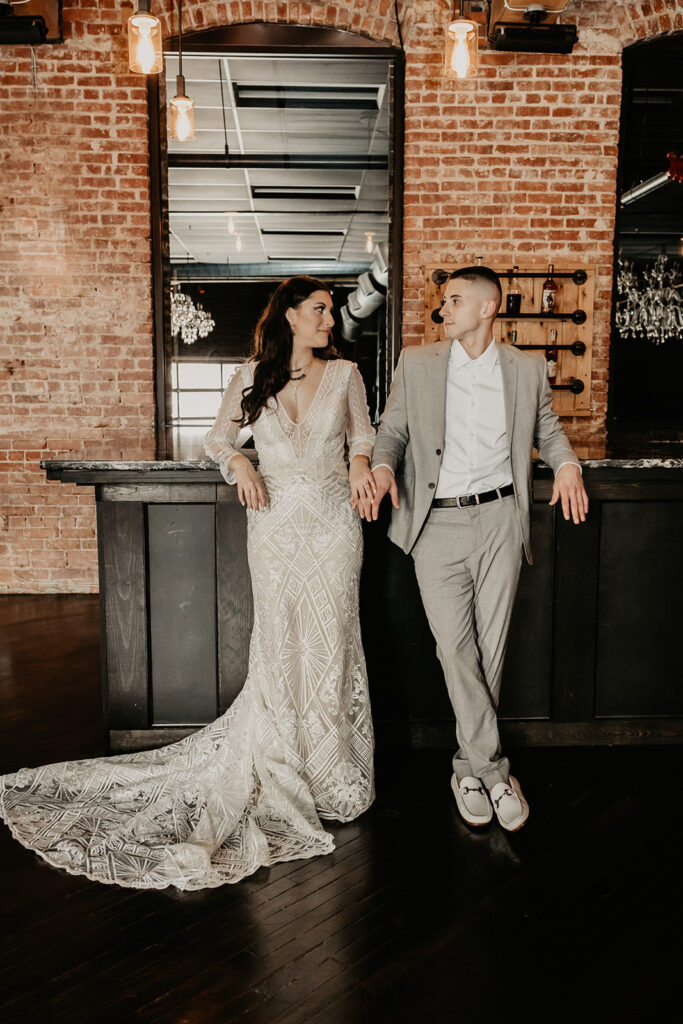 bride and groom standing in front of bar at wedding venue warehouse 435 in lebanon, pa