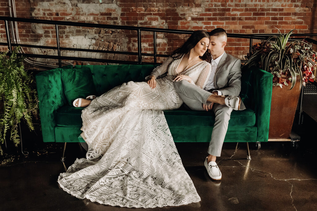 bride and groom sitting on green couch at industrial wedding venue warehouse 435 in lebanon, pa