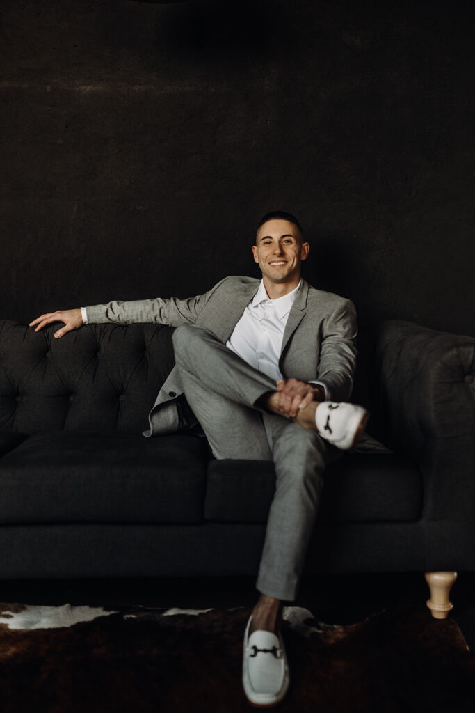 groom sitting on couch at industrial wedding venue in lebanon, pa at warehouse 435