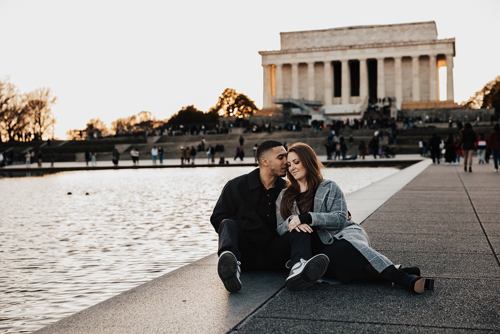 A joyful couple’s engagement photos in historic Washington DC, posing in front of classic architecture and city landmarks.