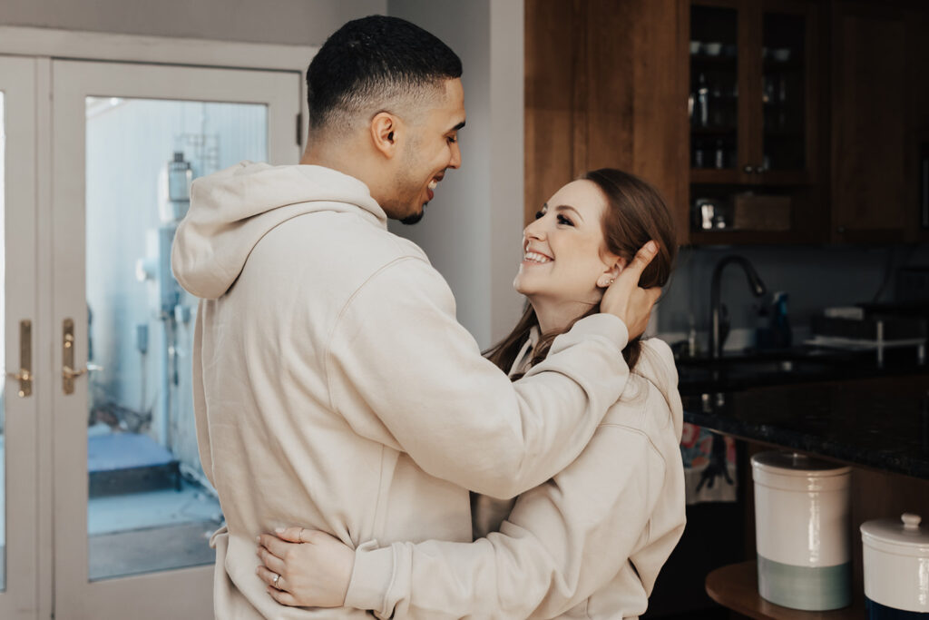 Engagement photos of a couple in their cozy Washington DC home, sharing warm moments together in a relaxed, intimate setting.