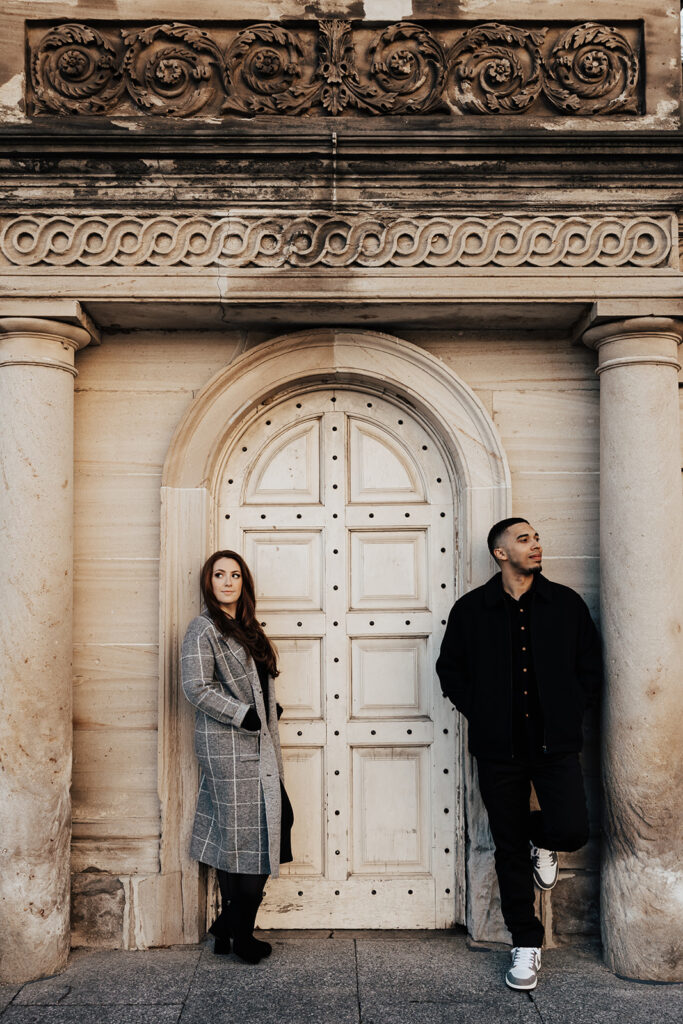 A joyful couple’s engagement photos in historic Washington DC, posing in front of classic architecture and city landmarks.