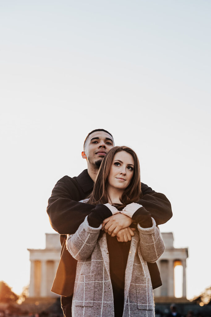 A joyful couple’s engagement photos in historic Washington DC, posing in front of classic architecture and city landmarks.